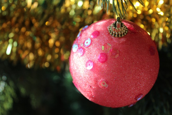 pink sequined bauble on golden tinsel
